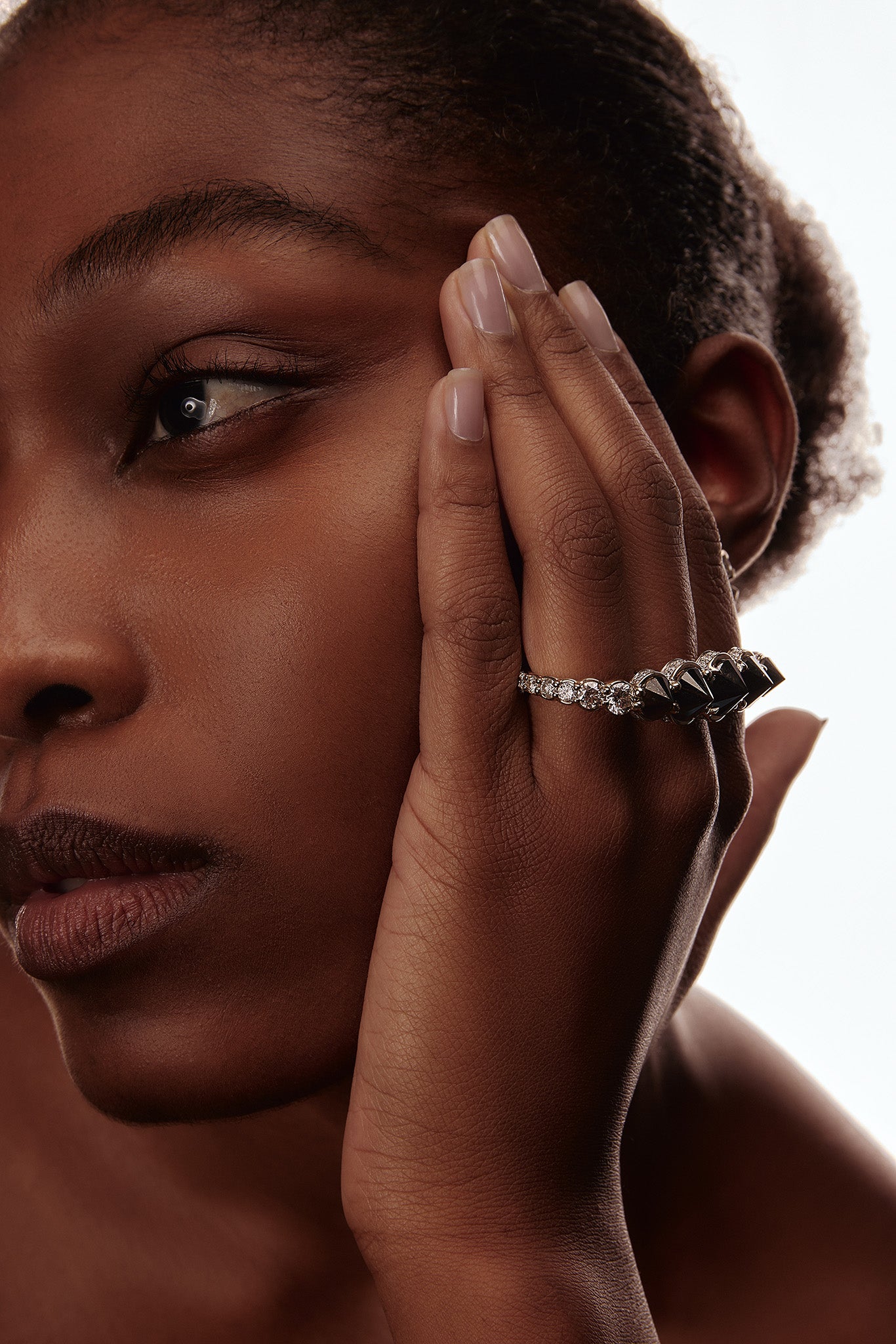 Inverted black diamond three-finger ring with white diamonds in 18k white and yellow gold